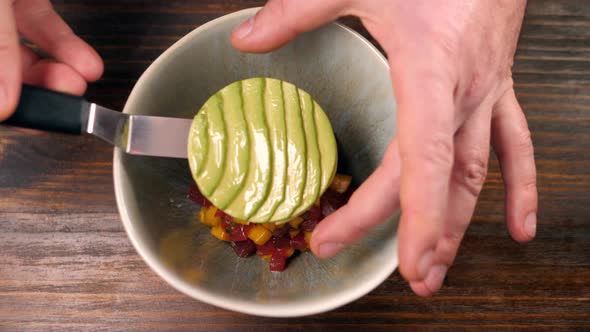 Extreme Close Up of Fresh Salmon Tuna and Avocado Tartar in Restaurant Cafe Poke Bowl Chef Decorate alt