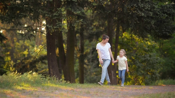 Mother And Daughter on a Walk in a Garden alt