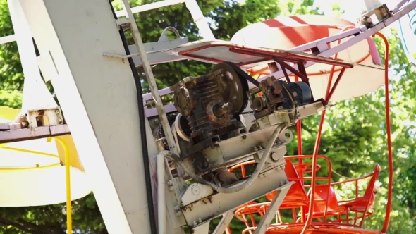 Motor Rotates Ferris Wheel And Cabins Move One After The Other
