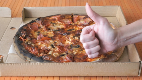 A Gesture Of a Hand, Showing Fingers Up Over Pizza
