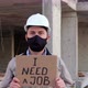 Engineer in Mask and Hardhat Shows Placard I Need a Job - VideoHive Item for Sale
