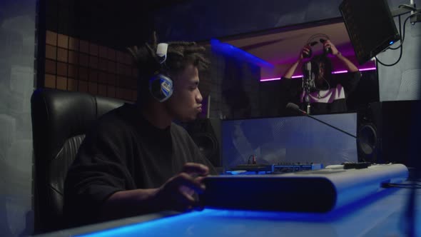 Black Male Sound Producer Dissatisfied with Working Process of Recording New Track in Studio alt