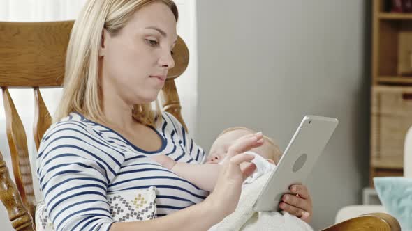 Modern Mother Rocking Baby Son to Sleep alt