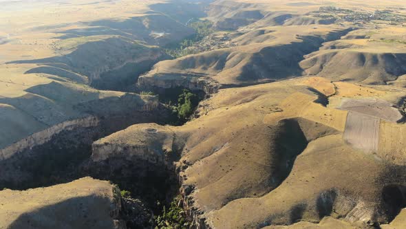 Aerial Deep Long Rift Canyon with Cleft Steep Rock Walls and High Cliff Gorge alt