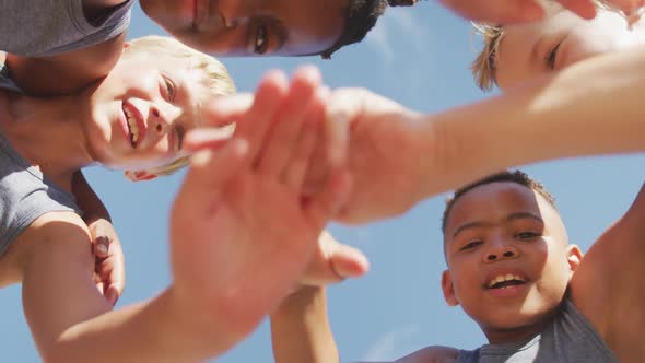 Video of happy diverse boys holding arms and clapping hands alt