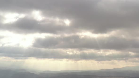 Dramatic cloudscape with rays of sun 4K aerial footage alt