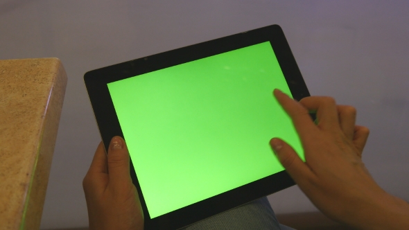 Female Hands Using Tablet Pc With Green Screen In Shopping Mall. alt