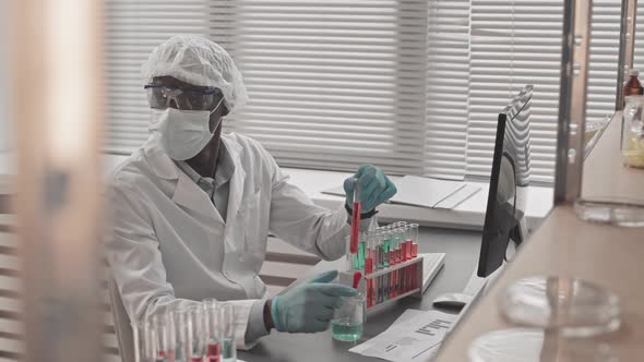 Black Man Working with Test Tubes alt