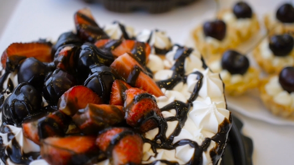 Cake With Strawberry And Cream With Chocolate On Table