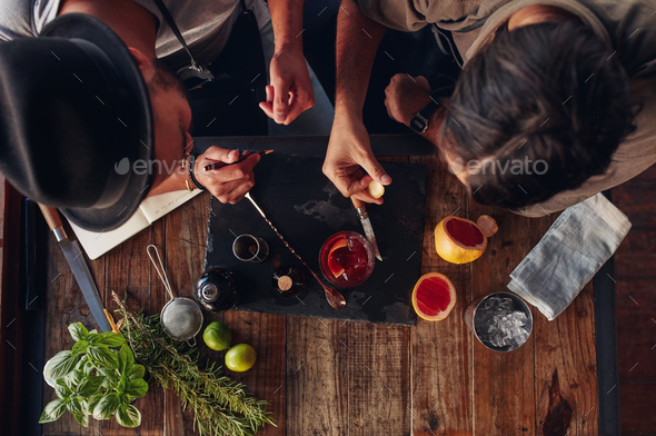 Two bartenders discussing creative recipe ideas for cocktails - Stock Photo - Images