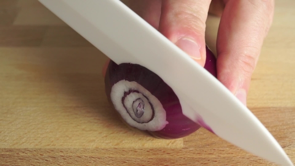 Amateur Cooking Of Greek Salad. Part Of The Set. Man Cutting Red Onion alt