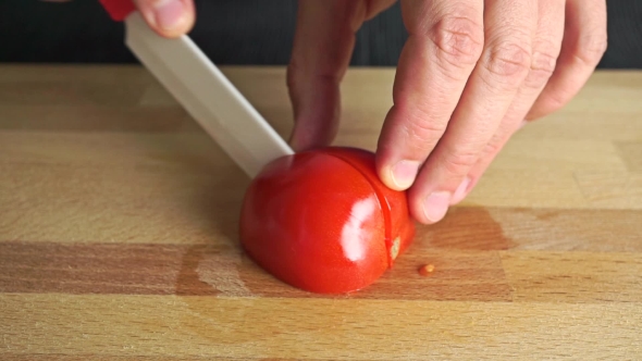 Amateur Cooking Of Greek Salad. Part Of The Set. Man Cutting Red Tomato alt