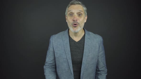 Aged Man with Grey Beard and Hair Performs Surprise and Joy alt