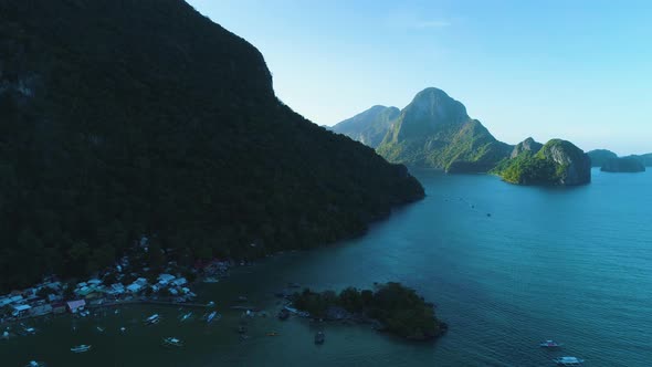 Aerial orbit view of beautiful islands in El Nido, Palawan, Philippines. Shot at dawn during a sunny alt
