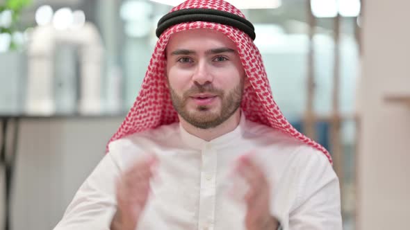Attractive Arab Businessman Doing Video Chat in Office  alt