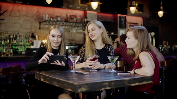 Company Of Young People Is Taking Selfie And Clinking Glasses In The Bar alt