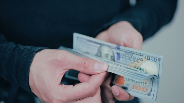 Man Shows Money US Dollars On His Workplace In Office. alt