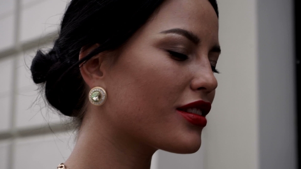 Stylish And Attractive Girl Walks Through The City Along Shops
