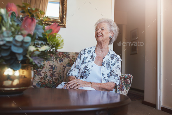 Senior woman sitting on a sofa at old age home