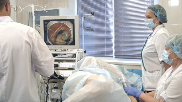 Doctors conducting surgery using endoscope