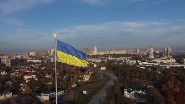 the national flag of Ukraine and the statue of liberty over Kyiv, panorama right