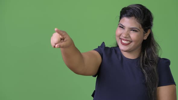 Young Overweight Beautiful Indian Businesswoman Against Green Background alt