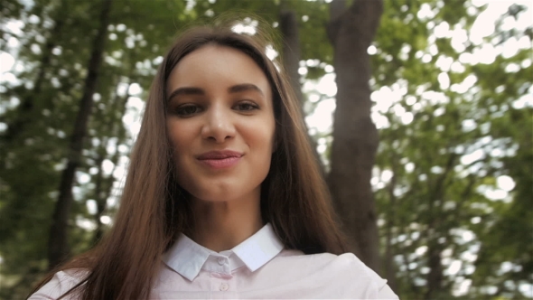 Selfie Girl Concept. Young Pretty Happy Student Model Smiling And Walking In Park. alt