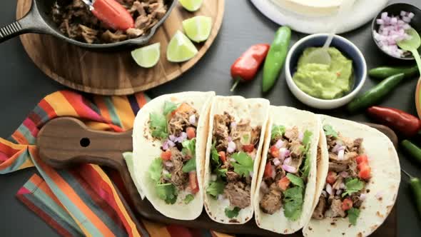 Pulled pork carnitas with pico de gallo on a flour tortilla. alt