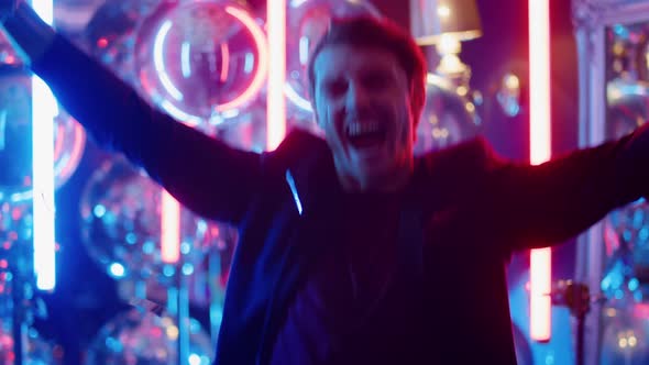 Victory Man Making Win Gestures at Party. Winner Guy Jumping in Nightclub alt