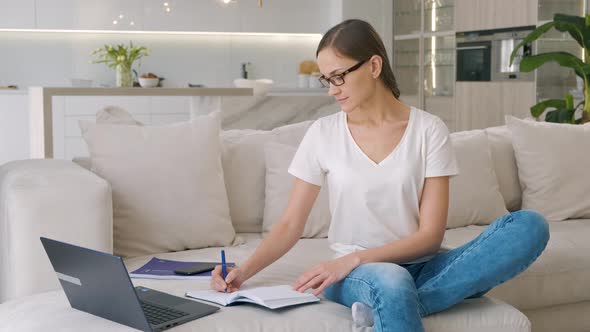 Young Woman in Glasses Working at Home alt