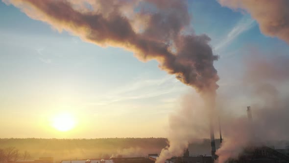 smoke from factory chimneys on the background of sunrisee