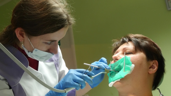 Woman Receiving A Dental Treatment alt