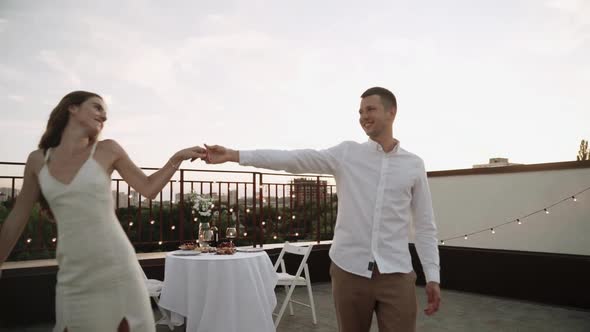 Couple Dancing and Kissing on the Roof