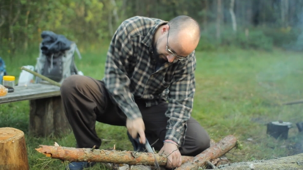 Man Sawing a Small Branch 