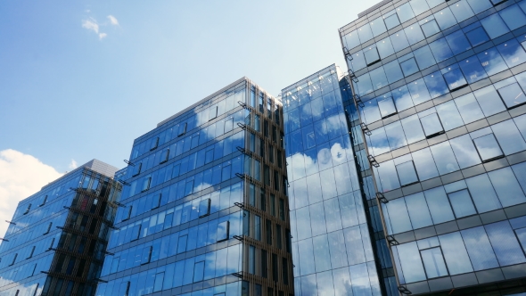 Office Building Skyscraper in the Windows of which reflected the passing clouds alt