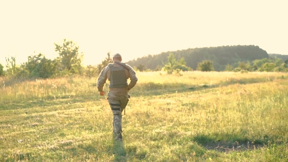 Military Man With Automaton Go Away In The Steppe. Slowly alt