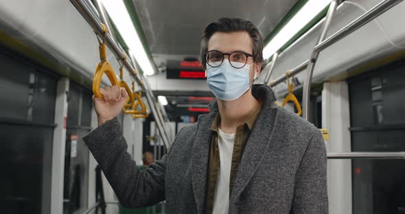 Portrait of Guy in Protective Medical Mask Turning Head and Looking To Camera alt
