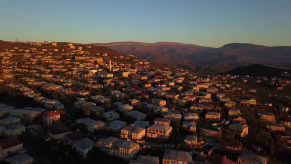 Sunset in the mountains city. Panoramic aerial view of Derbent ancient city.	