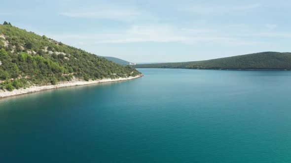 Aerial shot of a lagoon in Croatia near Luca Beach, Istria. Camera tracks slowly to the side. alt