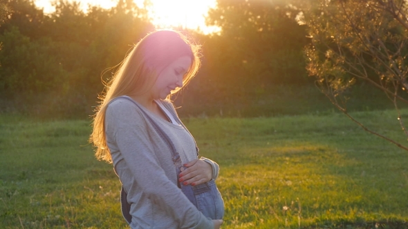 Beautiful Pregnant Woman On Grass alt