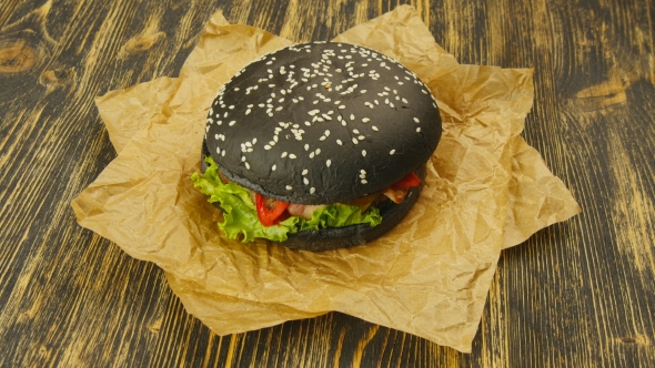Black Burger on Wooden Table alt