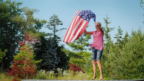Sporty Woman with Usa Flag Jumping on Trampoline alt