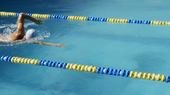 Professional Swimmer Swimming the Crawl in Outdoor Pool alt