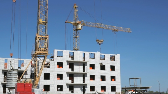 A Construction Crane Delivers Cement For Builders