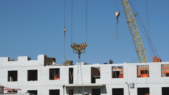 A Construction Crane Delivers Cement For Builders