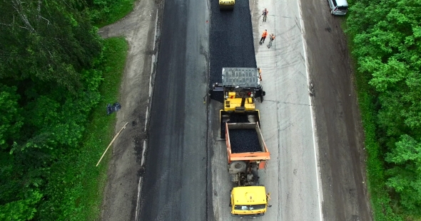 Road Construction Workers With Paving Machine