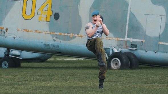 Soldier Trains Fighting Skills. He Performs a Series Of Punching And Kicking. alt