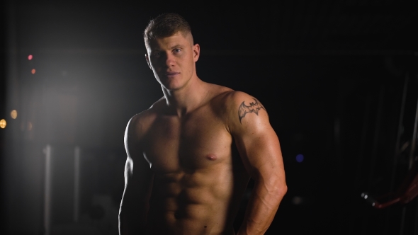 Bodybuilder On Top Form. Beautiful Young Athlete Posing For a Photo Session alt