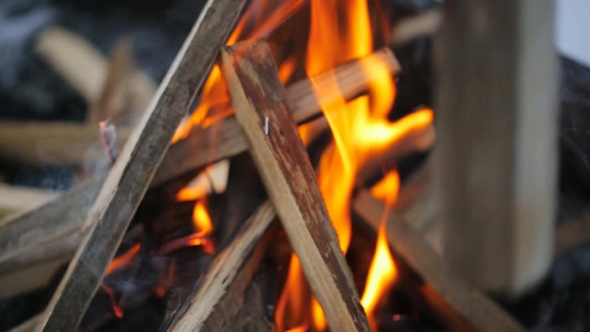 Bonfire With a Strong Flame In Form Of a Hut In Which Puts Board In Winter alt