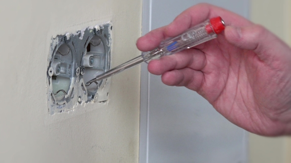 Electrician Hand Test Power On Wall Socket